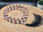 Preview: Handgefertigte Rudraksha & Quartz Mala aus Nepal mit feinen Metall-Spacern und schwarzer Quaste.